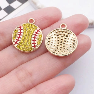 Detailed close-up of handmade baseball charms with yellow rhinestones and gold-tone backing