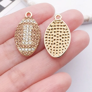 Detail of oval pendants with rhinestone pavé and honeycomb hollow back design
