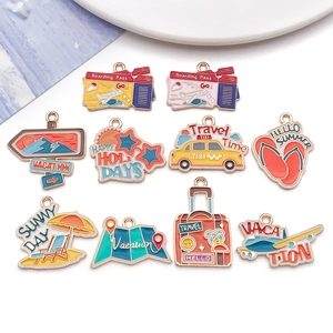 Detail of travel themed enamel charms featuring taxis and luggage for DIY jewelry