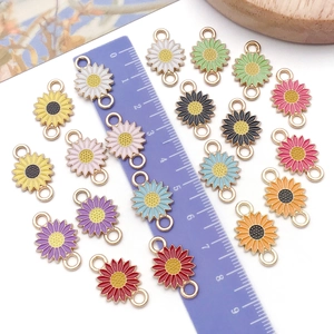 Detailed macro view showing the 1.5cm colorful enamel daisy charms with dual connector rings