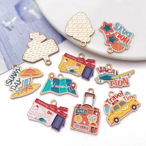 Macro shot of colorful enamel travel charms including boarding pass, taxi, and suitcase