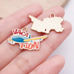 Detail of alloy airplane charm with VACATION text for DIY jewelry making and crafts