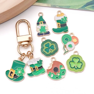 Detailed view of St. Patrick's Day enamel charms and lucky shamrock pendants on white background