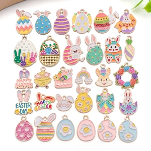 Detailed close-up of colorful enamel Easter charms with rabbit and egg motifs for DIY crafts
