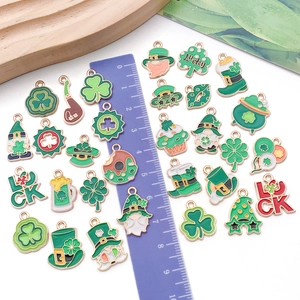 Saint Patrick's Day green enamel clover and gnome charms with ruler for size reference