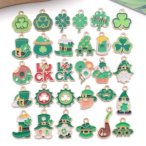 Macro detail of St. Patrick's Day green enamel clover and gnome charms for DIY jewelry making
