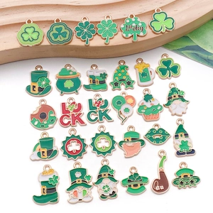 Detailed close-up of green St. Patrick's Day enamel charms with lucky clovers and gold coins