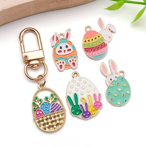 Easter rabbit and egg enamel pendant set with gold keychain hook on white background