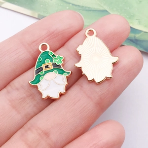 Detail of a green St. Patrick's Day gnome charm with a golden clover pattern on the back