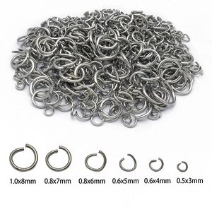 Various sizes of stainless steel open jump rings for DIY jewelry making on white background