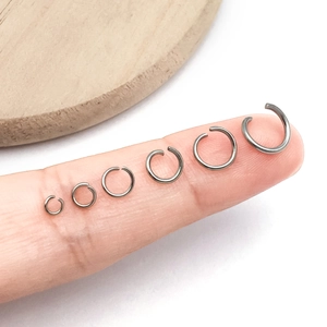 Detail view of 6 varied sizes of stainless steel open jump rings for DIY jewelry making