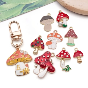 Macro shot of colorful enamel mushroom alloy charms and keychain with pearl details