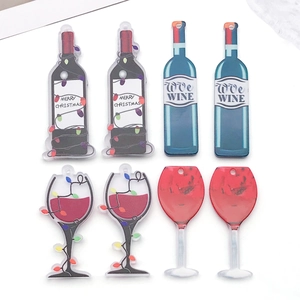 Flat lay of acrylic Christmas wine bottle and glass charms for DIY jewelry making
