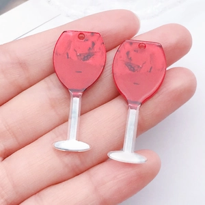 Macro view of two acrylic red wine glass pendants with realistic wave texture and hang holes