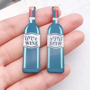 Close-up of blue acrylic wine bottle pendants with We Wine text for DIY jewelry
