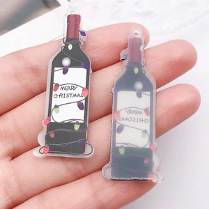 Close-up of acrylic wine bottle charms with Merry Christmas festive holiday design