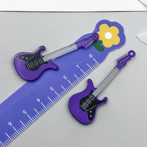 Detailansicht zweier lila Acryl-Gitarrenanhänger mit Größenangabe auf einem Lineal