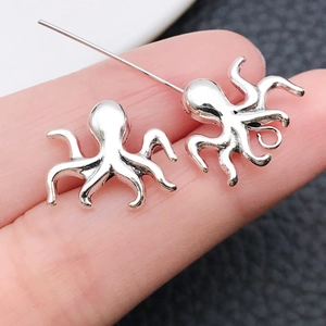 Gedetailleerd overzicht van twee antieke zilveren octopus hangers voor DIY-sieraden