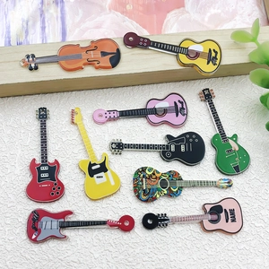 Close-up of colorful acrylic guitar and violin charms for DIY jewelry making