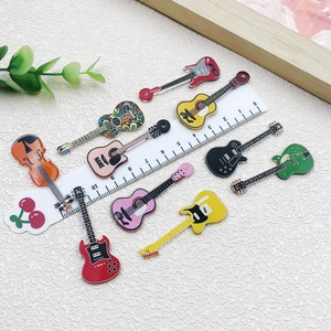 Colorful acrylic guitar and violin pendants for DIY necklaces or keychains displayed on white