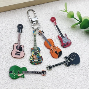 Close-up of six colorful acrylic guitar and violin charms with silver metal keychains
