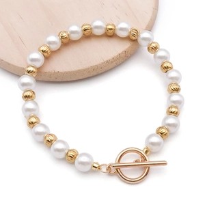Detail view of pearl bracelet with textured gold beads and elegant OT toggle clasp