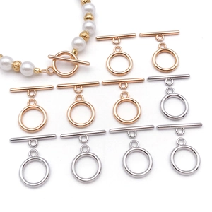 Macro detail of polished gold and silver OT toggle clasps for jewelry making projects
