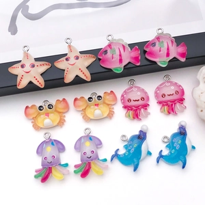 Macro view of ocean animal resin charms featuring starfish and dolphin for DIY crafts