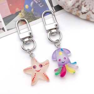 Detail view of resin ocean animal charms with starfish and octopus on a white background