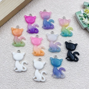 Detailed view of colorful gradient cat resin charms with metal loops for DIY jewelry making