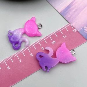 Macro detail of glittery resin cat pendant with pink and purple gradient finish