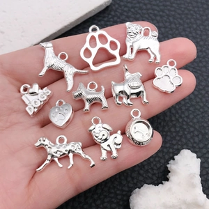 Detailed set of 11 silver dog-themed alloy charms featuring paw prints and bone designs