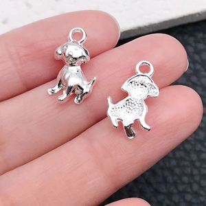 Detailed view of silver dog charms for DIY jewelry showing front and back textures