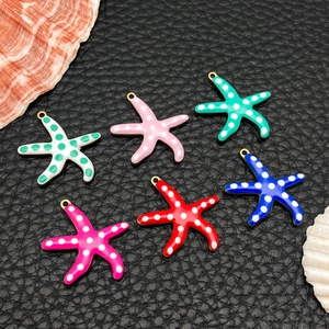 Macro detail of six colorful starfish charms with gold plated rings for DIY jewelry making