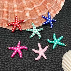 Polka dot starfish pendants in six colors on black background for DIY jewelry