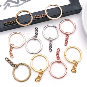 Close-up of colorful metal keyrings with tail chains in gold, silver, and bronze plating