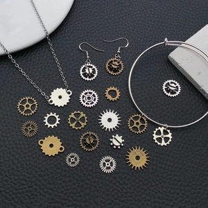 Steampunk gear jewelry set including necklaces and earrings on dark leather background