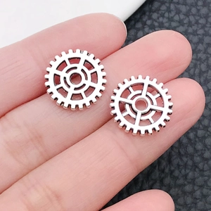 Macro detail of silver vintage gear pendants for steampunk jewelry and DIY crafts