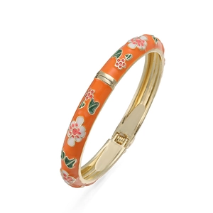 Detail of orange enamel bangle with floral patterns and gold spring hinge