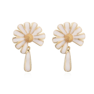 Detailed macro view of daisy earrings with white enamel petals and gold frame