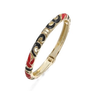 Detailed macro view of vintage cloisonne floral bangle with gold finish and spring hinge