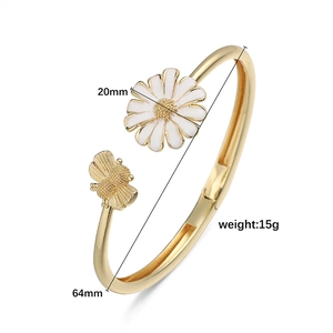 Detail of white daisy and golden bee motif on adjustable bangle showing size dimensions