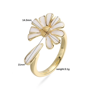 Golden open ring featuring a white daisy flower with enamel petals and textured core