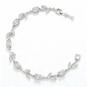 Detail of silver leafy bracelet with marquise and oval cut crystals on white background