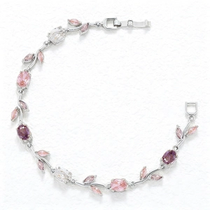Detail of silver vine bracelet featuring pink and purple crystals with leaf-shaped stones