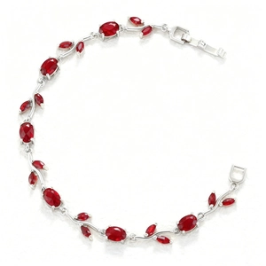 Detail of leaf-shaped vine bracelet with oval red gemstones and marquise accents