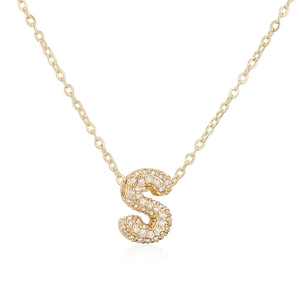 Detailaufnahme der goldenen O-Kette mit einem zirkonia-besetzten S-Buchstabenanhänger