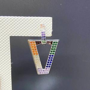 Detailed macro view of V-shaped earrings with colorful pavé micro-set cubic zirconia