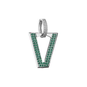 Macro shot of V-shaped silver earring pendant with pave-set green crystals and white diamonds