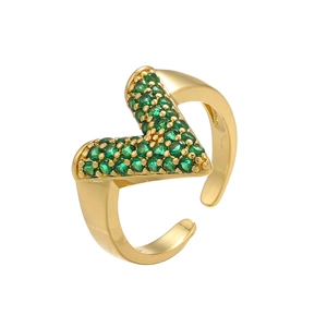 Detailed macro view of gold adjustable V-shape ring with green pavé cubic zirconia